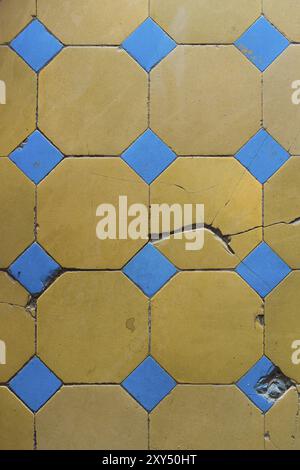 Close-up of an old floor tile with a two-tone pattern. Chapped floor tiles Stock Photo