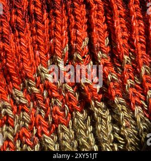 Pattern fabric made of wool. Handmade knitted fabric red and beige wool background texture Stock Photo