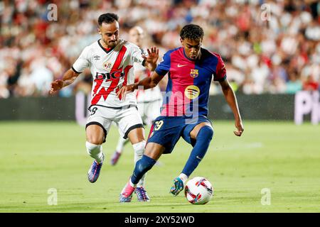 Alvaro Garcia of Rayo Vallecano and Lamine Yamal of FC Barcelona during the Spanish championship La Liga football match between Rayo Vallecano and FC Barcelona on 27 August 2024 at Vallecas stadium in Madrid, Spain Stock Photo