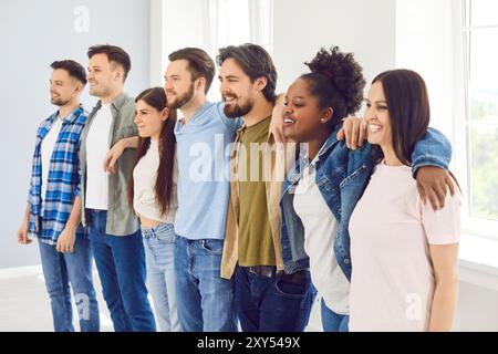 Happy Group Of Young People Embracing Each Other Stock Photo