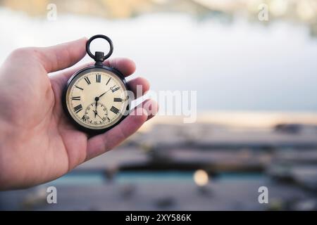 Hand held stop watch outdoors, autumn, blurry background Stock Photo