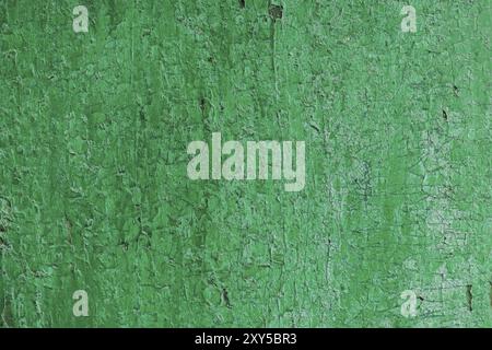 Texture of a wooden board in green, Cracked from time green paint on a wooden surface Stock Photo