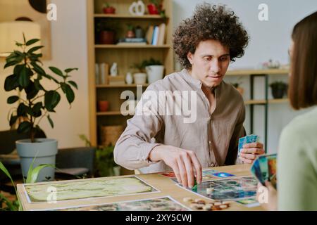 Young Man Playing Board Game With His Girl Friend Stock Photo