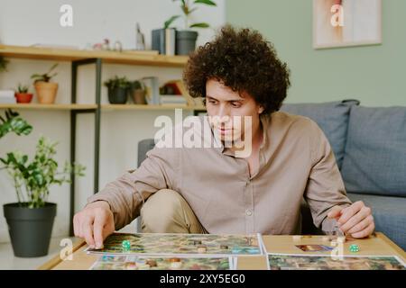 Pensive Man Playing Board Game Stock Photo