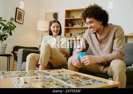 Couple Enjoying Playing Tabletop Game Stock Photo