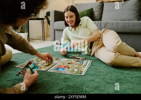 Couple Having Fun Playing Tabletop Game Stock Photo