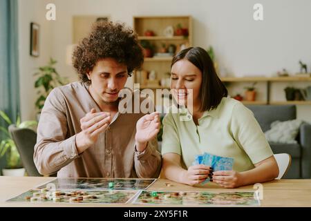 Couple Playing Modern Thematic Tabletop Game Stock Photo