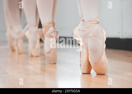 People, shoes and ballet dancers with toes on floor for lesson or class in row, line or studio. Closeup of female person or ballerina group with feet Stock Photo