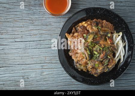 Fried asian green mussel omelette thaifood Stock Photo