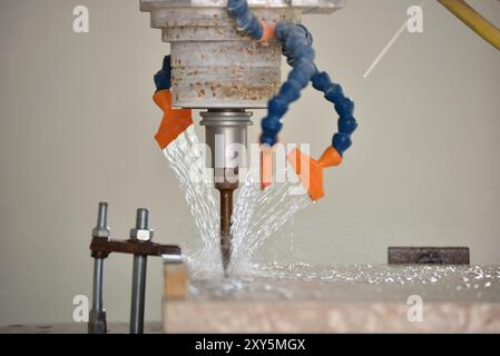 Robot working on milling sculpture in natural stone Stock Photo