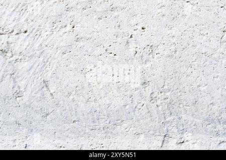 Close-up Deep texture of white-painted porous stone on the facade of the building. Stoned wall background texture Stock Photo