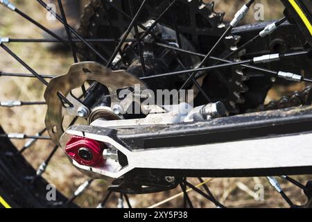 A close-up of the disc rear brakes of an off-road enduro motorcycle. The concept of motorsport Stock Photo