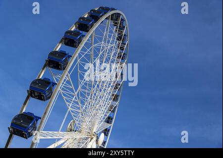 Ferris wheel in front of a blue sky on Burgplatz Stock Photo