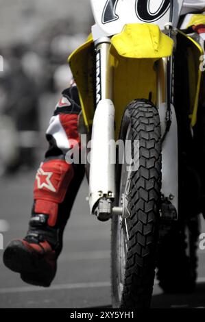 Motorcyclist on a racing motorbike closeup of the wheel Stock Photo