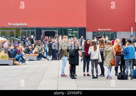 Young students on the grounds of Leipzig University during a break Stock Photo