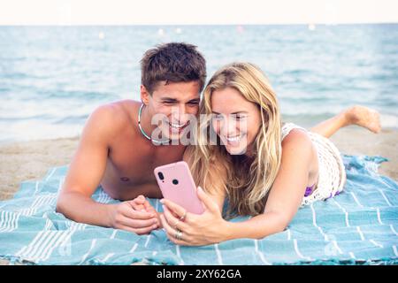 Young couple using smartphone app outdoors. Stock Photo
