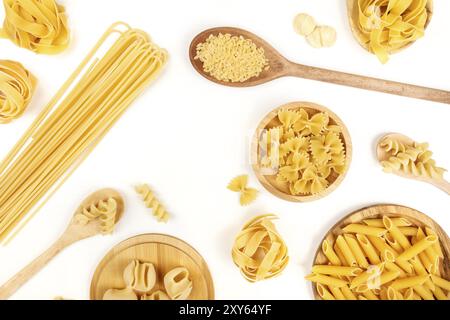 An overhead photo of different types of pasta, including spaghetti, penne, fusilli, and others, forming a frame, shot from above on a white background Stock Photo