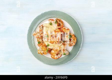 Fired shrimps with a sauce, shot from the top on a light blue background with a place for text Stock Photo