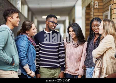 Break, corridor and students talking for learning, research study and school education in university. Diversity, college and happy friends at campus Stock Photo