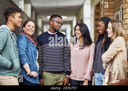 Break, corridor and students in university talking for learning, research study and school education. Diversity, college and happy friends at campus Stock Photo