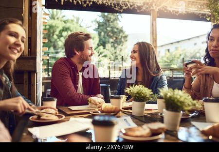 Smile, friends and chat in restaurant for lunch, brunch and breakfast with conversation for hangout. People, man and women with happiness for social Stock Photo