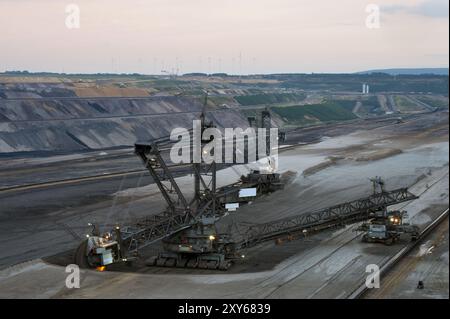 Bucket-wheel excavator wheel excavator in an open-cast mine at dusk Stock Photo