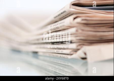 A pile of old yellowed daily newspapers Stock Photo