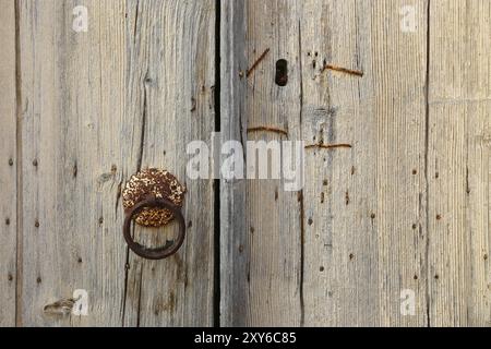 Old wooden door with round handle Stock Photo