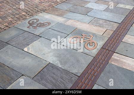 Stone paved bicycle path in Jonkoping, Sweden. Surface in old town made of flagstones. Cycling transportation infrastructure. Stock Photo