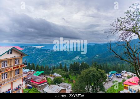 Thick monsoon clouds hangs over the mountains around Narkanda, Himachal Pradesh, India. Hotel Mount View is seen in the foreground. Stock Photo