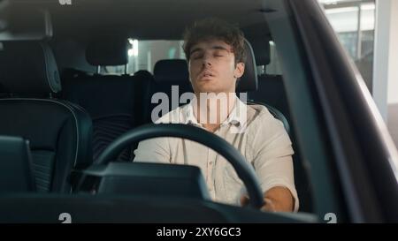 Caucasian business man driver male guy open door of new modern electric car sitting inside automobile problem tired health trouble exhausted stress Stock Photo