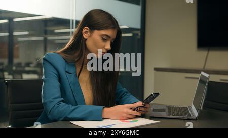 Caucasian woman Hispanic girl worker female businesswoman lady business designer office workplace employer at table with colorful circle laptop using Stock Photo