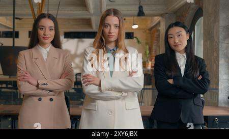 Feminity power confident serious professional business team women people colleagues females multiracial multiethnic girls businesswomen diversity Stock Photo