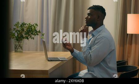 Pensive African American man think idea thinking ponder solution ethnic male biracial guy student business freelancer businessman at evening at home Stock Photo