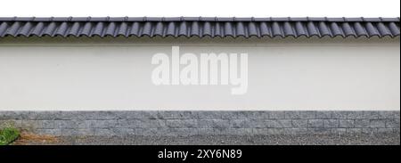 Long Japanese style fence with granite base and black tiles on top. Isolated on white Stock Photo