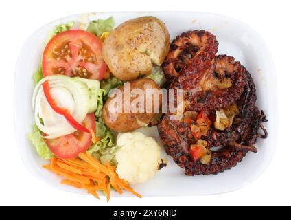 Grilled octopus with potatoes and vegetables. Isolated on white Stock Photo