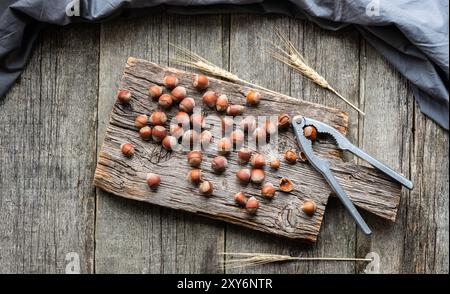 Hazelnut, heap or stack of hazelnuts on wooden background, healthy food Stock Photo