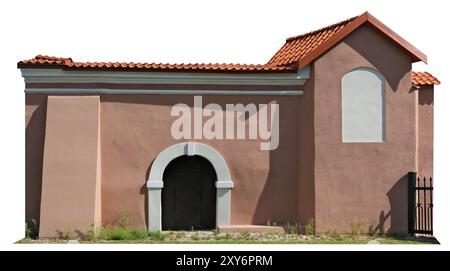 The wall of an ancient home with a red tiled roof and a small tower. Isolated on white Stock Photo