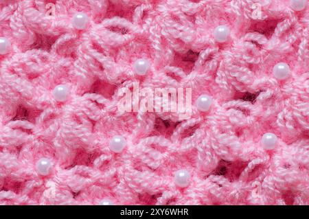 Pattern of pink knitted handmade baby clothes , knit pattern background, knitted texture backdrop Stock Photo