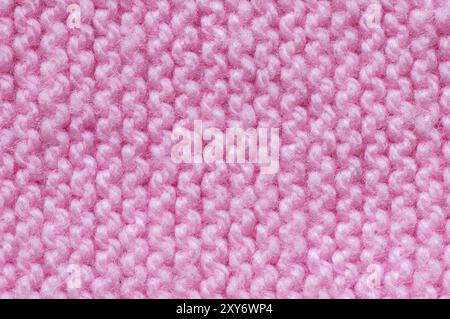Pattern of pink knitted handmade baby clothes , knit pattern background, knitted texture backdrop Stock Photo