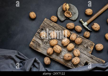 Ripe and raw whole big walnut kernel with shell on rustic backdrop. healthy nut food for brain Stock Photo