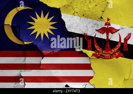 Flags of Malaysia and Brunei painted on cracked wall Stock Photo