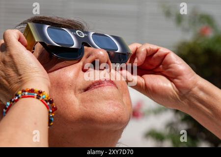 Mexico City, Mexico; 04 08 2024; A woman watching the total solar eclipse with a pair of solar glasses. Stock Photo