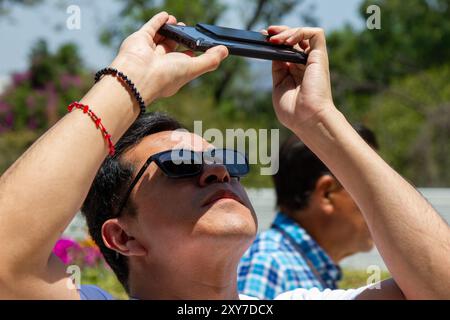 Mexico City, Mexico; 04 08 2024; A man watching the total solar eclipse with a welding glass. Stock Photo