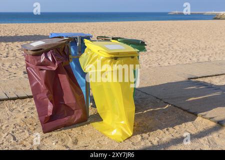 Empty garbage bags on portuguese beach at sandy coast Stock Photo