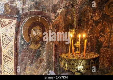 Candlelit orthodox wall painting in a dark, mystical setting, icon depicting Christ, church of Agia Anna, Lefka Ori, White Mountains, mountain massif, Stock Photo