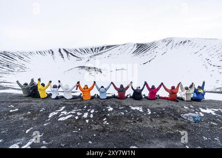 A group of adventurous friends on the Hverfjall volcano in Myvatn Nature Park, Iceland. Concept of an adventure holiday with friends enjoying a beauti Stock Photo