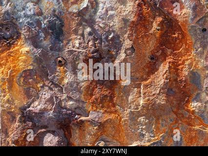Close up of an iron stained stone wall creating an irregular abstract shape Stock Photo
