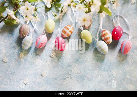 Easter background with Easter eggs and spring flowers. Top view with copy space Stock Photo