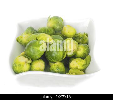 White designer bowl with fresh green brussel sprouts isolated on white Stock Photo